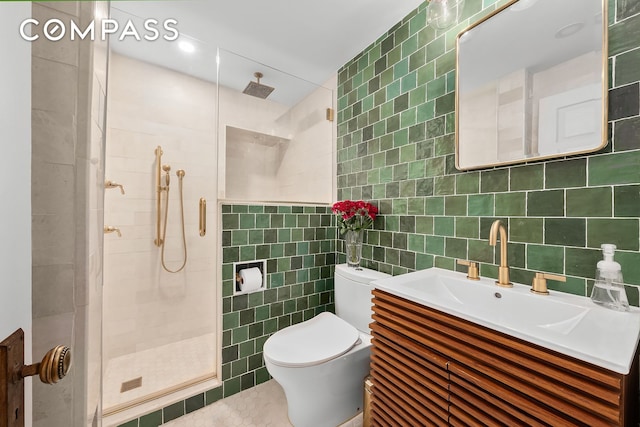 334 E 5th St Unit 2, New York City, NY 10003 - full bathroom featuring tile walls, a shower stall, toilet, and vanity