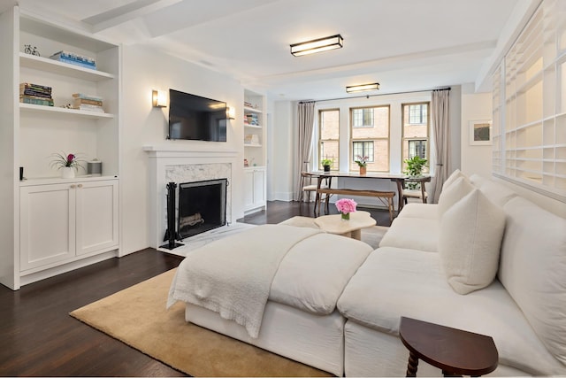 59 W 12th St Unit 4A, New York City, NY 10011 - living room featuring built in shelves, dark wood-style floors, and a premium fireplace