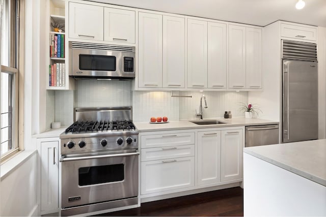 59 W 12th St Unit 4A, New York City, NY 10011 - kitchen featuring high quality appliances, a sink, light countertops, and white cabinetry