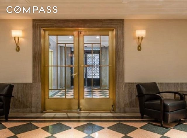 433 W 34th St Unit 8D, New York City, NY 10001 - doorway to outside featuring french doors and a wainscoted wall