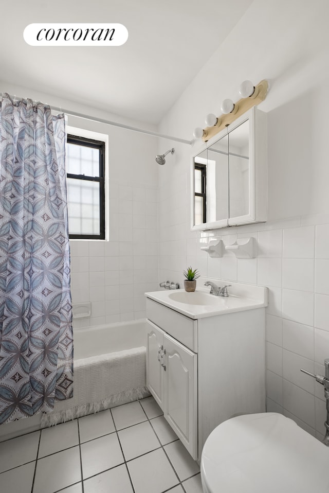202 Seeley St Unit 2E, New York City, NY 11218 - full bathroom featuring vanity, toilet, shower / bath combo with shower curtain, tile patterned floors, and tile walls