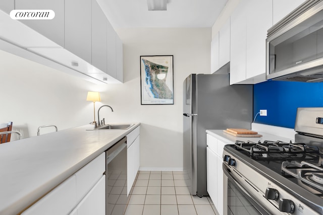 350 Albany St Unit 4F, New York City, NY 10280 - kitchen with appliances with stainless steel finishes, light countertops, white cabinets, and light tile patterned floors