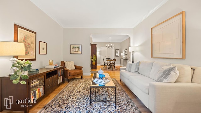 20 Plaza St E Unit A-8, New York City, NY 11238 - living room featuring arched walkways, a chandelier, crown molding, wood finished floors, and baseboards
