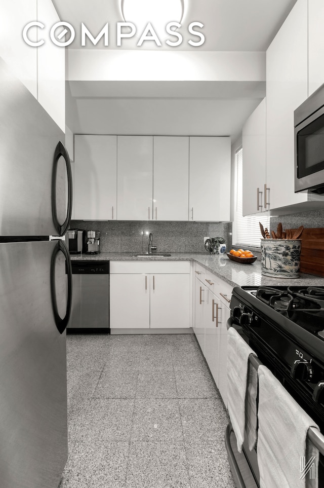 22-40 80th St Unit 3B, New York City, NY 11370 - kitchen with stainless steel appliances, white cabinets, tasteful backsplash, granite floors, and a sink
