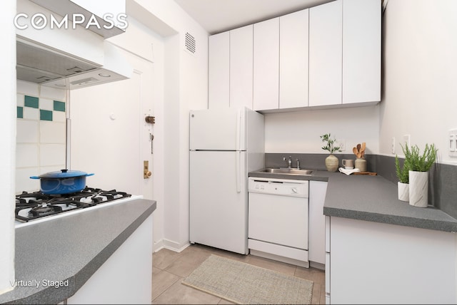 104 E 37th St Unit 5C, New York City, NY 10016 - kitchen featuring white appliances, a sink, white cabinetry, dark countertops, and light tile patterned flooring