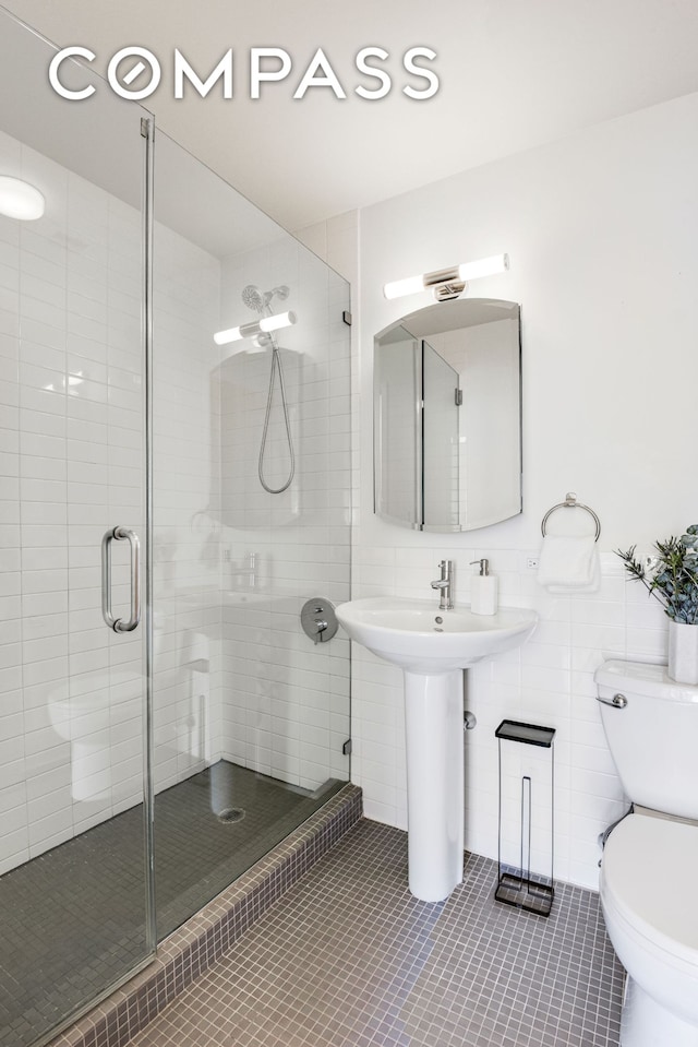 475 Sterling Pl Unit 3A, New York City, NY 11238 - bathroom with tile patterned flooring, a stall shower, and tile walls