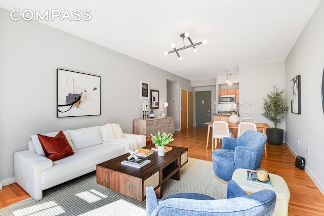 475 Sterling Pl Unit 3A, New York City, NY 11238 - living room featuring a chandelier and light wood-style flooring