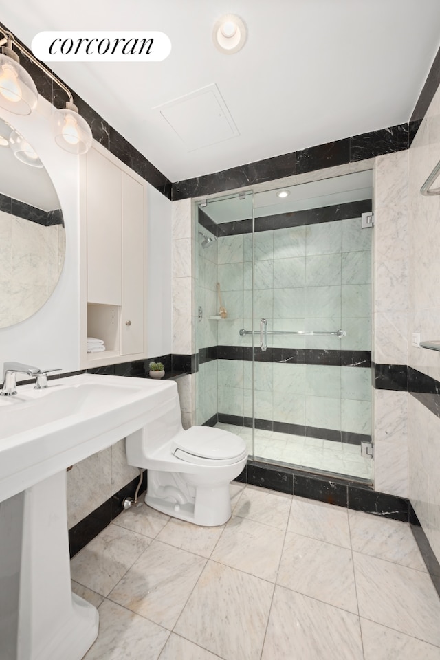150 W 56th St Unit 3502, New York City, NY 10019 - bathroom featuring toilet, a stall shower, a sink, and recessed lighting