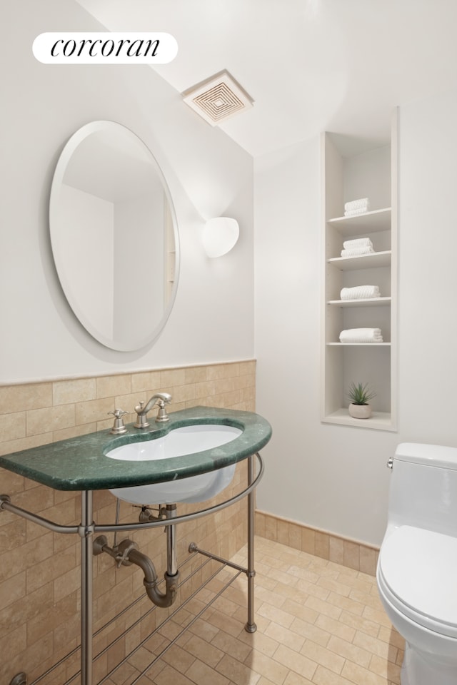 150 W 56th St Unit 3502, New York City, NY 10019 - bathroom with toilet, tile patterned flooring, and a sink