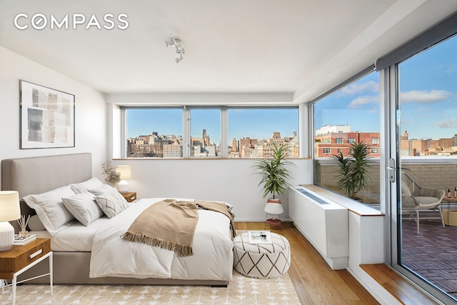 2280 Frederick Douglass Blvd Unit 11E, New York City, NY 10027 - bedroom with hardwood / wood-style flooring and a view of city