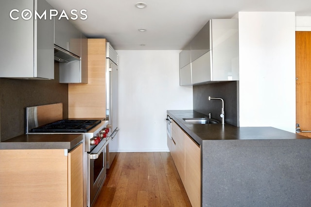 2280 Frederick Douglass Blvd Unit 11E, New York City, NY 10027 - kitchen featuring a sink, dark countertops, high end appliances, modern cabinets, and recessed lighting