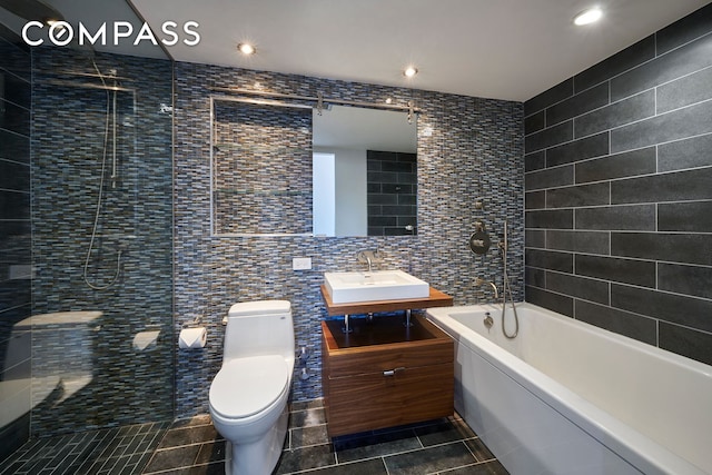 2280 Frederick Douglass Blvd Unit 11E, New York City, NY 10027 - bathroom featuring tile walls, tile patterned flooring, toilet, vanity, and a bathtub