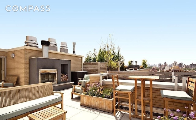 2280 Frederick Douglass Blvd Unit 11E, New York City, NY 10027 - view of patio with an outdoor living space with a fireplace