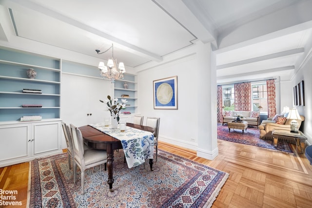 51 E 90th St Unit 5B, New York City, NY 10128 - dining area with a chandelier, beam ceiling, baseboards, and built in features