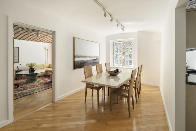 27 W 67th St Unit 2Fe, New York City, NY 10023 - dining space with track lighting, baseboards, and light wood-style flooring