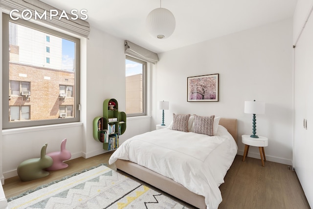 116 University Pl Unit 5, New York City, NY 10003 - bedroom with wood finished floors, multiple windows, and baseboards
