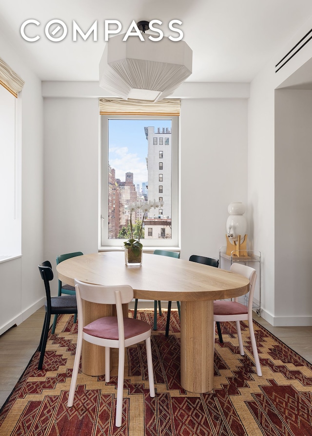 116 University Pl Unit 5, New York City, NY 10003 - dining space with wood finished floors, baseboards, and a view of city