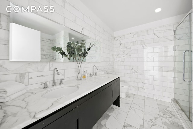 225 5th Ave Unit 7K, New York City, NY 10010 - bathroom with double vanity, toilet, a stall shower, marble look tile flooring, and tile walls