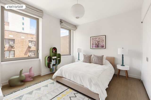 116 University Pl Unit 5Th, New York City, NY 10003 - bedroom featuring wood finished floors, multiple windows, and baseboards