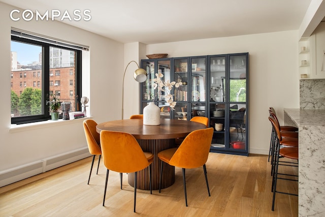 1325 5th Ave Unit 3K, New York City, NY 10029 - dining room featuring light wood-style flooring and baseboards