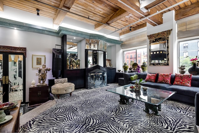 205 E 22nd St Unit 2L, New York City, NY 10010 - carpeted living room featuring a wood ceiling with exposed beams