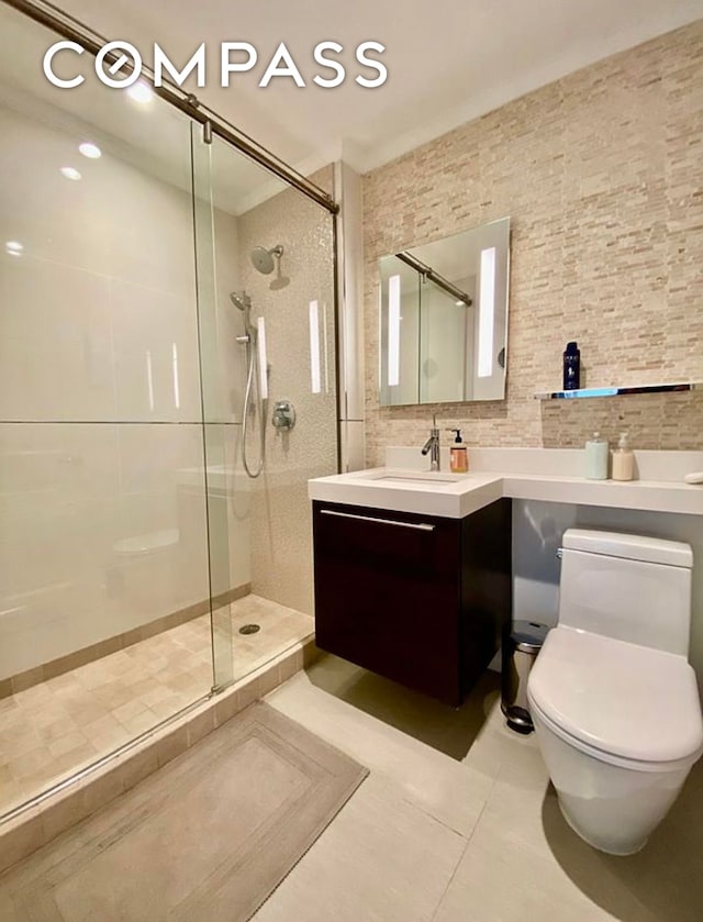 404 E 76th St Unit 30A, New York City, NY 10021 - bathroom featuring tiled shower, tile patterned floors, toilet, and vanity