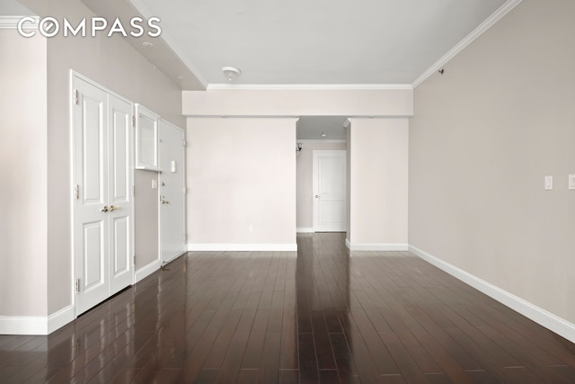 404 E 76th St Unit 30A, New York City, NY 10021 - unfurnished living room featuring baseboards, crown molding, and dark wood-style floors