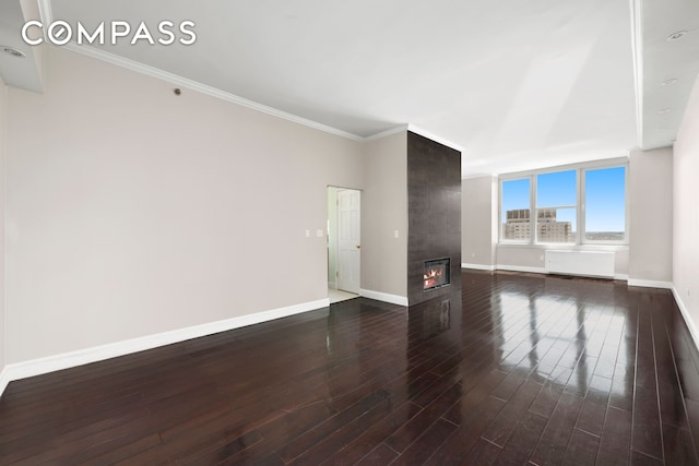 404 E 76th St Unit 30A, New York City, NY 10021 - unfurnished living room featuring dark wood-style floors, baseboards, crown molding, and a tile fireplace