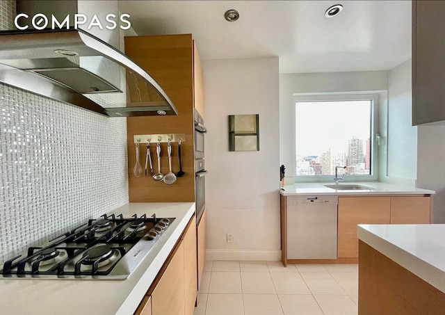 404 E 76th St Unit 30A, New York City, NY 10021 - kitchen with white dishwasher, stainless steel gas cooktop, a sink, light countertops, and light tile patterned floors