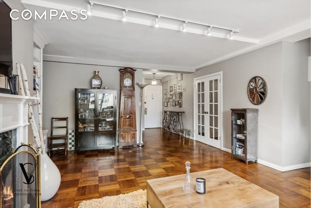 235 E 73rd St Unit 12C, New York City, NY 10021 - living area featuring track lighting, french doors, and a fireplace