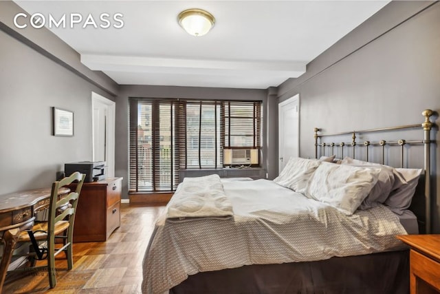 235 E 73rd St Unit 12C, New York City, NY 10021 - bedroom featuring cooling unit, wood finished floors, beam ceiling, and a desk