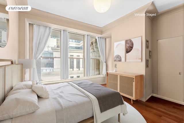 55 Wall St Unit 730, New York City, NY 10005 - bedroom featuring wood finished floors, radiator, and baseboards