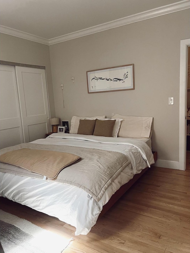 1890 Adam C Powell Blvd Unit 5C, New York City, NY 10026 - bedroom featuring a closet, wood finished floors, crown molding, and baseboards