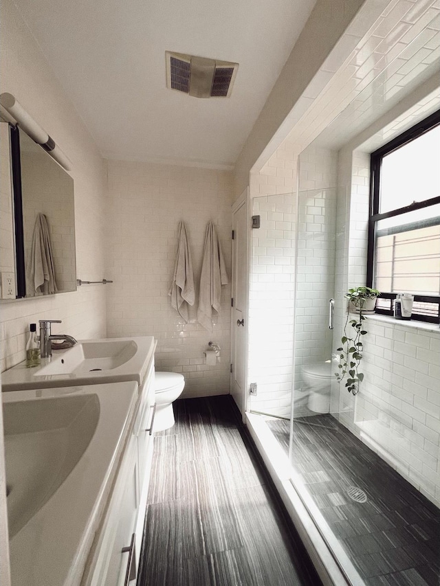 1890 Adam C Powell Blvd Unit 5C, New York City, NY 10026 - bathroom featuring double vanity, tile walls, and a shower stall