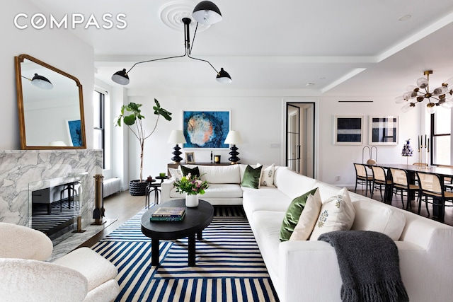 975 Park Ave Unit 14D, New York City, NY 10028 - living area featuring radiator, a high end fireplace, and a chandelier