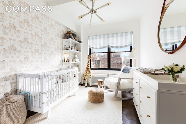 975 Park Ave Unit 14D, New York City, NY 10028 - bedroom with a chandelier, wallpapered walls, and dark wood-type flooring