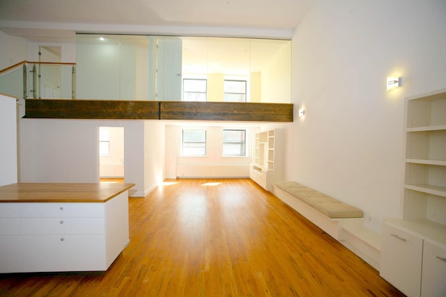 259 21st St Unit 1C, New York City, NY 11215 - unfurnished living room with wood finished floors and a high ceiling