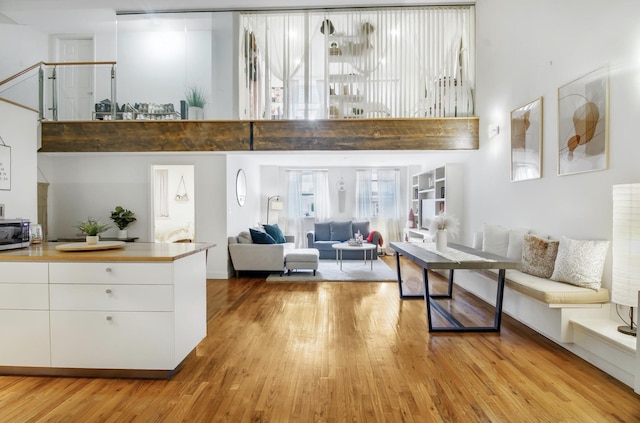 259 21st St Unit 1C, New York City, NY 11215 - living room with a towering ceiling and light wood-style floors
