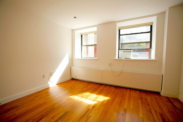 259 21st St Unit 1C, New York City, NY 11215 - spare room with radiator, light wood-type flooring, and baseboards