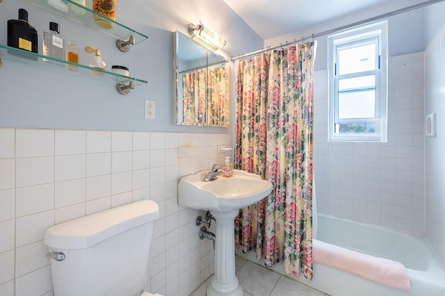 315 W 232nd St Unit 3-C, New York City, NY 10463 - bathroom with tile walls, shower / bath combo with shower curtain, and tile patterned floors