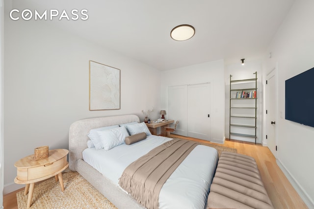 176 W 87th St Unit 1H, New York City, NY 10024 - bedroom featuring light wood finished floors, a closet, and baseboards