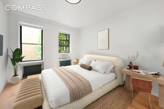 176 W 87th St Unit 1H, New York City, NY 10024 - bedroom featuring radiator heating unit, wood finished floors, and an office area