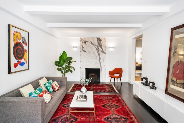 325 E 72nd St Unit 12C, New York City, NY 10021 - living room with beamed ceiling, dark wood-style floors, a high end fireplace, and baseboards