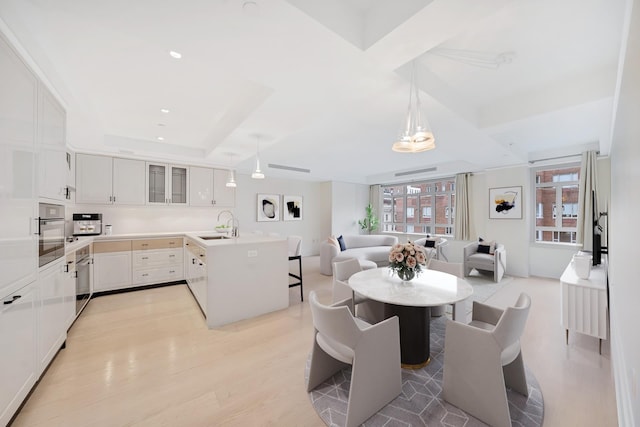 21 E 61st St Unit 9D, New York City, NY 10065 - dining room featuring light wood-style floors and recessed lighting