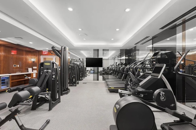 21 E 61st St Unit 9D, New York City, NY 10065 - exercise room featuring wine cooler, a tray ceiling, and recessed lighting