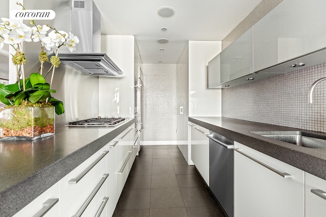 408 E 79th St Unit 9A, New York City, NY 10075 - kitchen featuring stainless steel appliances, island exhaust hood, a sink, dark tile patterned flooring, and backsplash