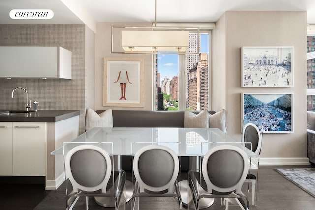 408 E 79th St Unit 9A, New York City, NY 10075 - dining space featuring dark wood-style flooring and baseboards