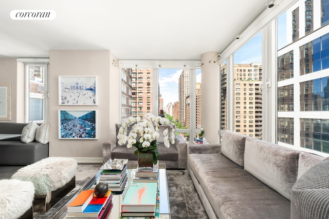 408 E 79th St Unit 9A, New York City, NY 10075 - living area with a city view and baseboards