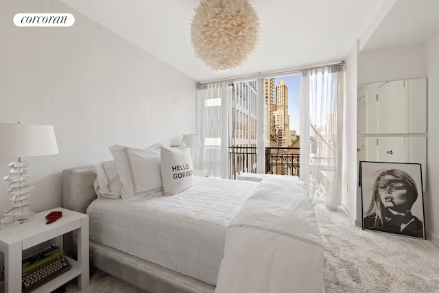 408 E 79th St Unit 9A, New York City, NY 10075 - carpeted bedroom with access to outside and a view of city