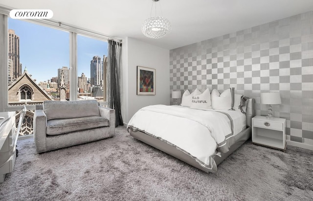 408 E 79th St Unit 9A, New York City, NY 10075 - bedroom with a skyline view, carpet floors, and a chandelier